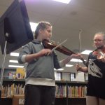 two students playing violin
